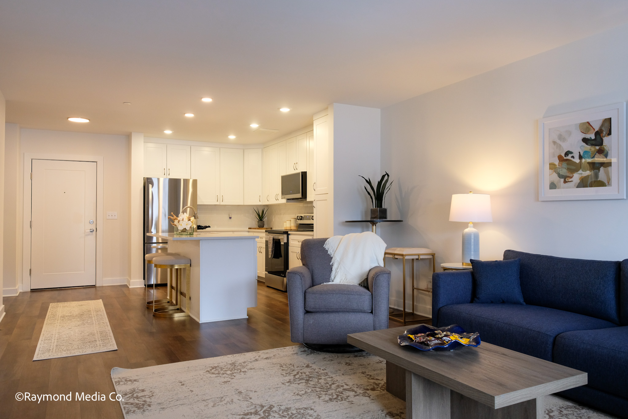 Modern open concept apartment living room in Auburn Maine with kitchen view